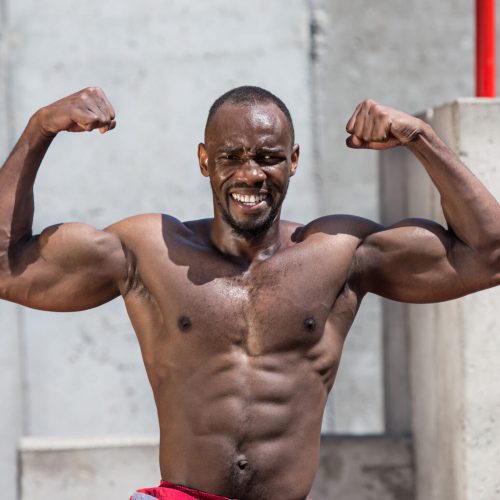 The fit athlete doing exercises at stadium. Afro or african american man outdoor at city. Pull up sport exercises. fitness, health, lifestyle concept